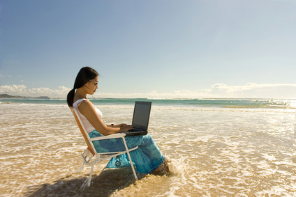 woman writing on laptop in ocean