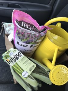 Rose food, green bamboo garden gloves, and friendly, bright yellow watering can