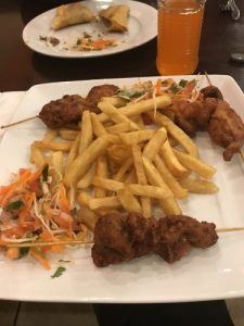 Mshikaki (Chicken skewers), fries, and Kachumbari (salad)