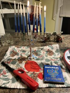 The menorah, Hanukkah candles, and book with the blessings